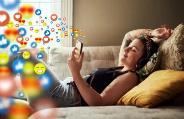 relaxed woman on mobile app network or streaming radio with heart emojis