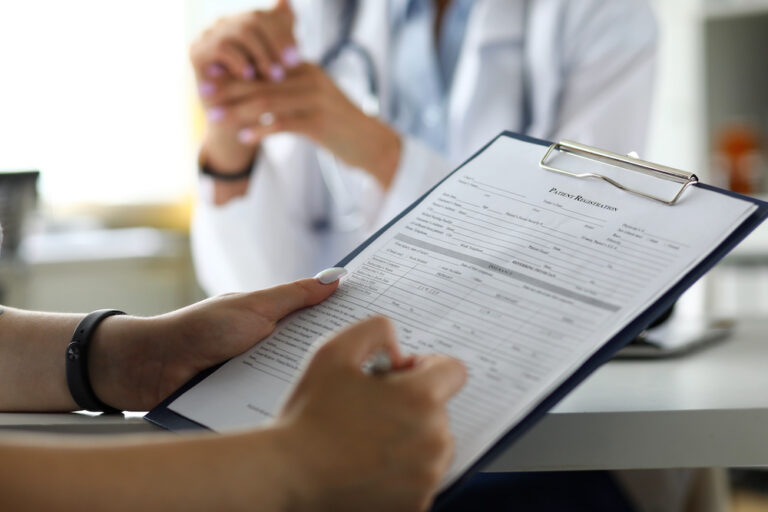 Female visitor filling out medicine documents