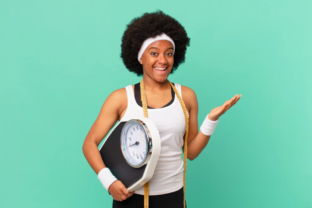 Afro woman feeling happy, surprised and cheerful, smiling with positive attitude, realizing a solution or idea diet concept