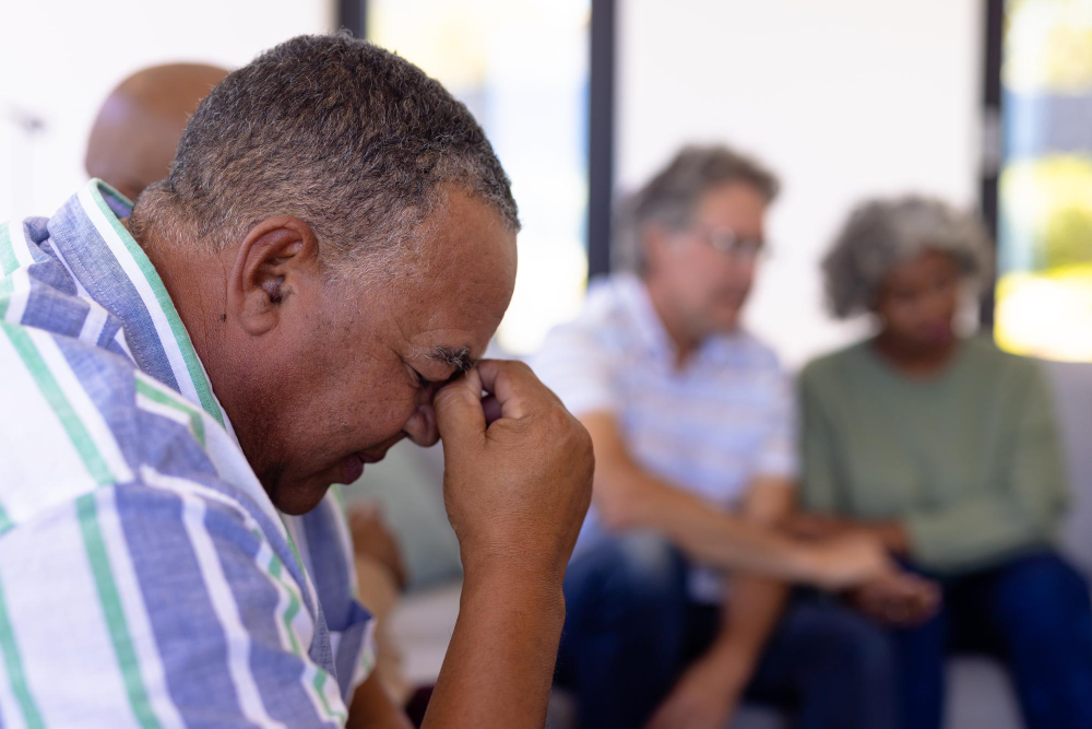 Social anxiety caucasian senior man with head in hand sitting