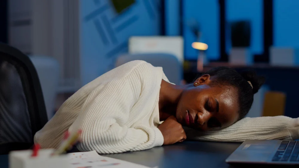 young woman sleep on the work table