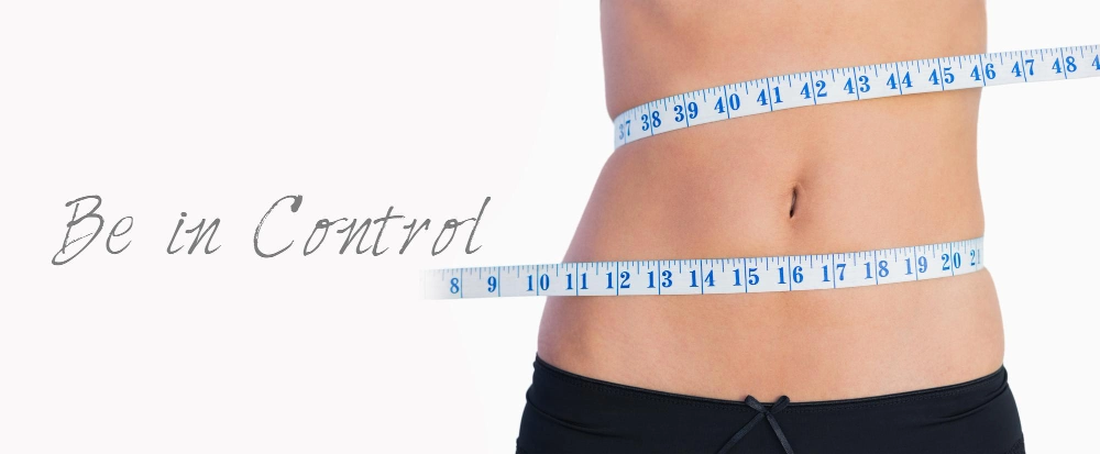 Fit belly surrounded by measuring tape on white background