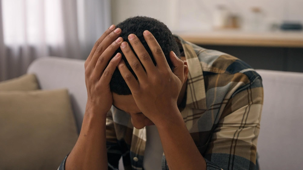 Anxious, stressed, sad, upset African American man suffering from panic attacks and panic disorder