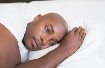 Unhappy man with Sleep Disorders in bed