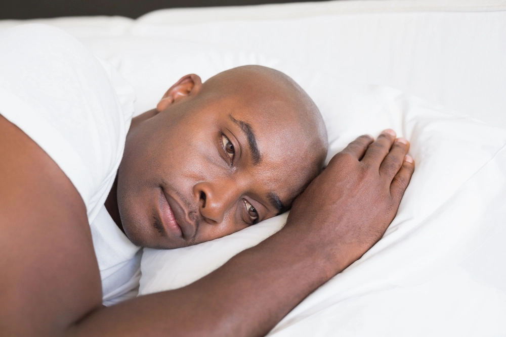 Unhappy man with Sleep Disorders in bed