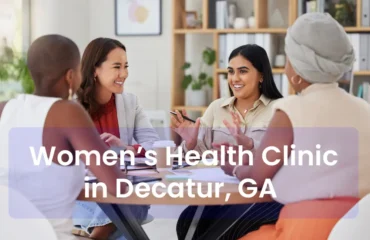 A diverse group of adult women (different ages, body types, and ethnicities) sitting in a bright, modern clinic space, laughing or talking with a provider.
